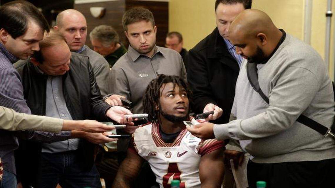 
Florida State running back Dalvin Cook, center, is surrounded by reporters during the team's media day Monday, Dec. 29, 2014, in Los Angeles. Florida State is scheduled to play Oregon in the Rose Bowl NCAA college football playoff semifinal on New Year's Day. 
