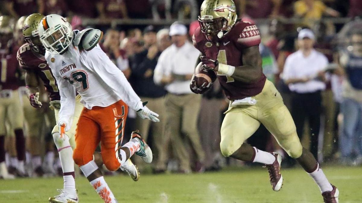 
Florida State's Dalvin Cook runs for a first down against Miami on Saturday, Oct. 10, 2015 in Tallahassee, Fla. 
