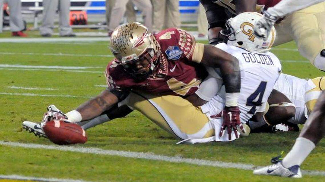 
FSU running back Dalvin Cook, stretching for the goal line, had 99 yards rushing and a touchdown in the first half. 
