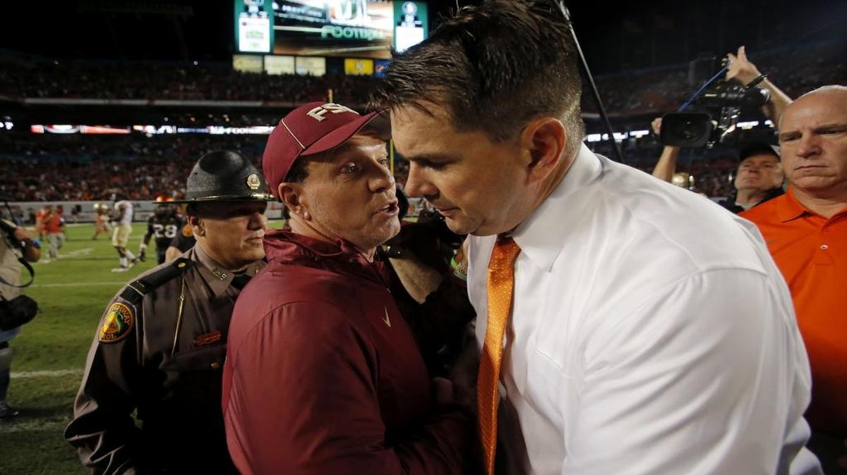 
Miami Hurricanes head coach Al Golden (right) and Florida State Seminoles head coach Jimbo Fisher meet at the center of the field following the Seminoles 30-26 victory over the Hurricanes at SunLife Stadium in Miami Gardens on Saturday, November 15, 2014.
