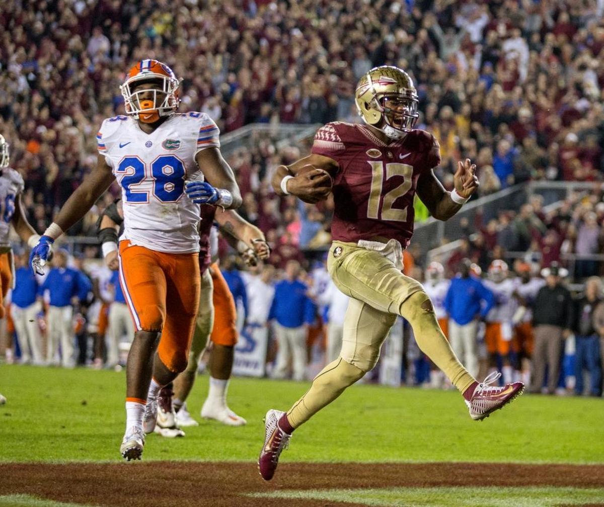 Florida State quarterback Deondre Francois reacts to scoring a touchdown in front of Florida linebacker Kylan Johnson on Nov. 26, 2016. Florida State defeated Florida 33-13.