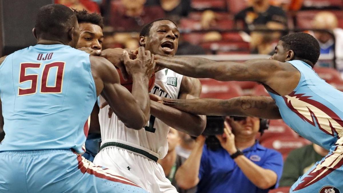 Manhattan Jaspers guard Aaron Walker Jr. (11) struggles to keep the ball as Florida State Seminoles center Michael Ojo (50) and guard Dwayne Bacon (4) defend as Florida State University plays Manhattan Jaspers at BB&T Center during the Orange Bowl Basketball Classic at BB&T Center on Saturday, Dec. 17, 2016.