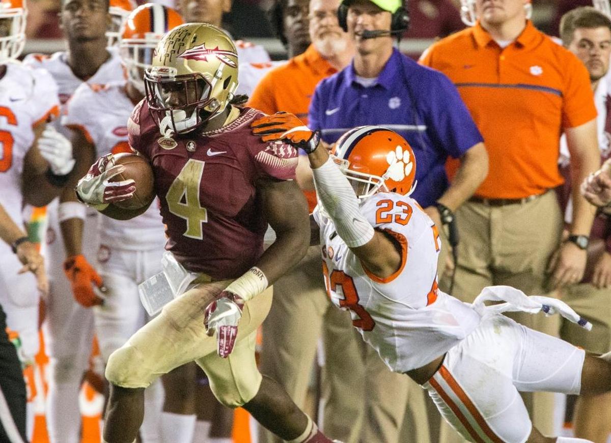 Florida State running back Dalvin Cook sheds Clemson safety Van Smith during a 70-yard touchdown run in the second half of FSU’s loss to the Tigers on Nov. 26, 2016.