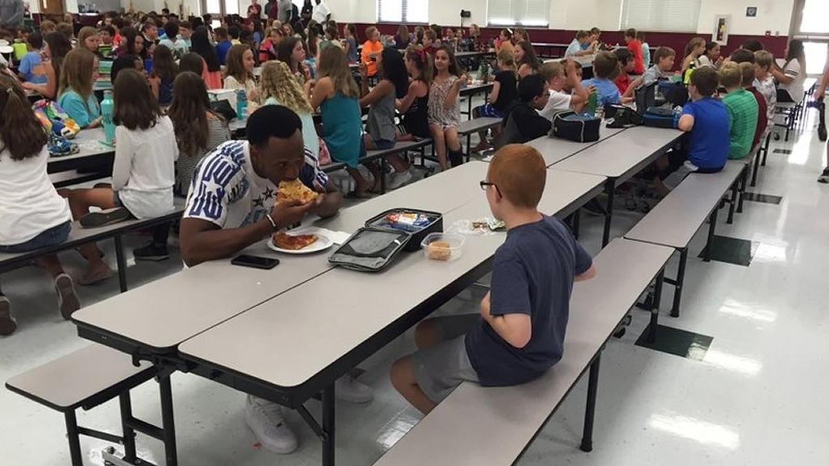 This photo of Florida State wide receiver Travis Rudolph joining autistic middle school student Bo Paske for lunch last August went viral. Rudolph, expected to be picked in the upcoming NFL draft, is in the headlines again after his father was fatally shot in a work accident.