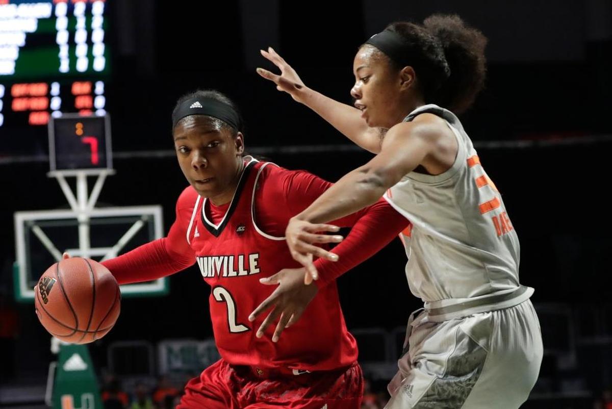 Louisville's Myisha Hines-Allen (2) drives to the basket as Miami's Erykah Davenport (30) defends during the first half of an NCAA college basketball game, Thurs., Jan. 25, 2018, in Coral Gables, Fla.