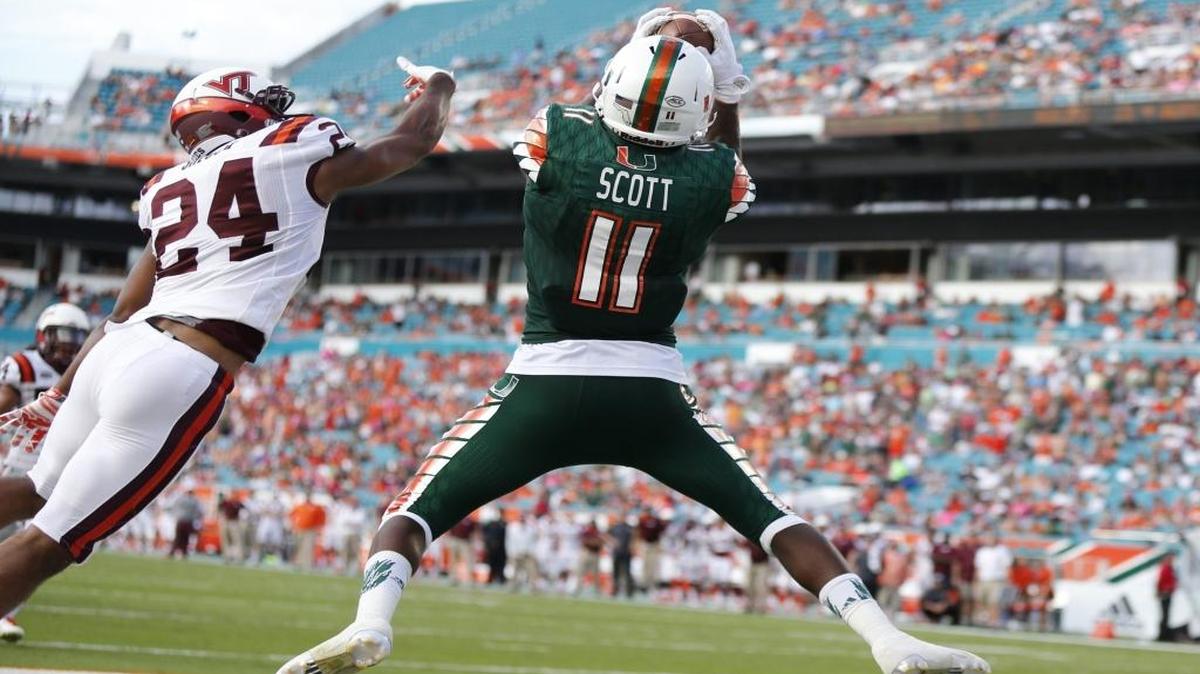 
UM wide receiver Rashawn Scott (11) scores in the second quarter as Virginia Tech’s Anthony Shegog (24) fails to make a stop as the University of Miami hosts Virginia Tech at Sun Life Stadium on Saturday, October 17, 2015.
