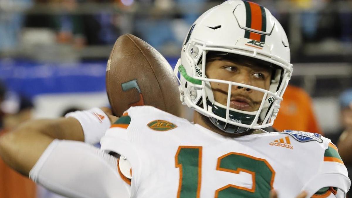Miami Hurricanes quarterback Malik Rosier (12) tries to keep warm Saturday during his game against the Clemson Tigers in the ACC Championship Game at Bank of America Stadium in Charlotte.