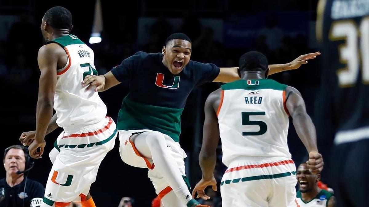 Miami's Kamari Murphy, left, and Davon Reed (5) celebrate with teammates after defeating Wichita State 65-57 in a second-round game in the NCAA men's college basketball tournament in Providence, R.I., Saturday, March 19, 2016.