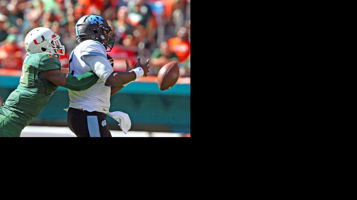 
UM’s Deon Bush strips the ball from UNC quarterback Marquise Williams in the third quarter Saturday. Bush also had an interception.
