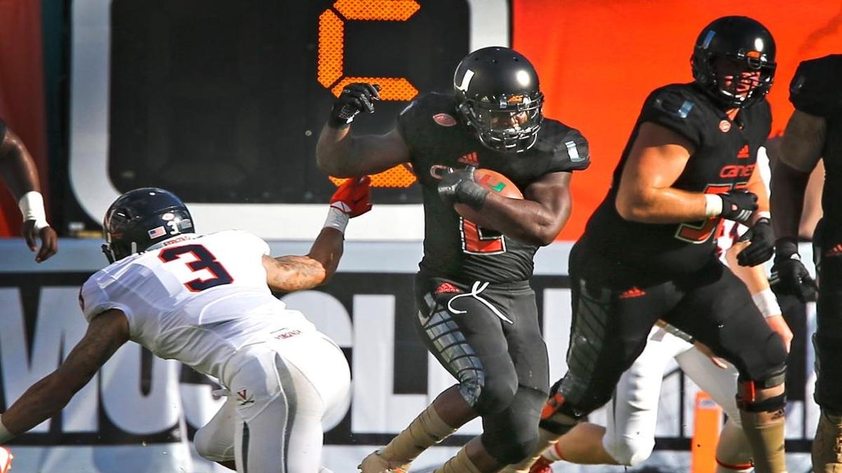 UM’s Joseph Yearby runs the ball in the first quarter against Virginia at Sun Life Stadium in Miami Gardens on November 7, 2015.