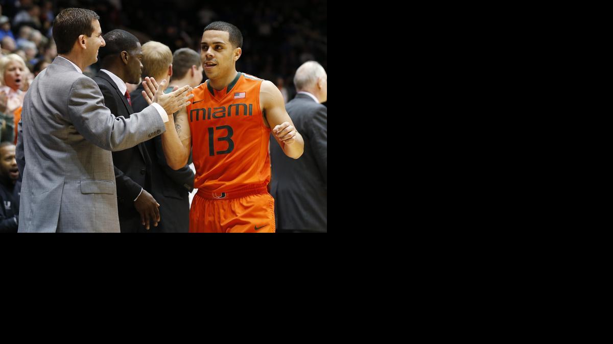 
Miami's Angel Rodriguez is congratulated after coming off of the court during the second half of an NCAA college basketball game against DukeTuesday, Jan. 13, 2014 in Durham, N.C. 

