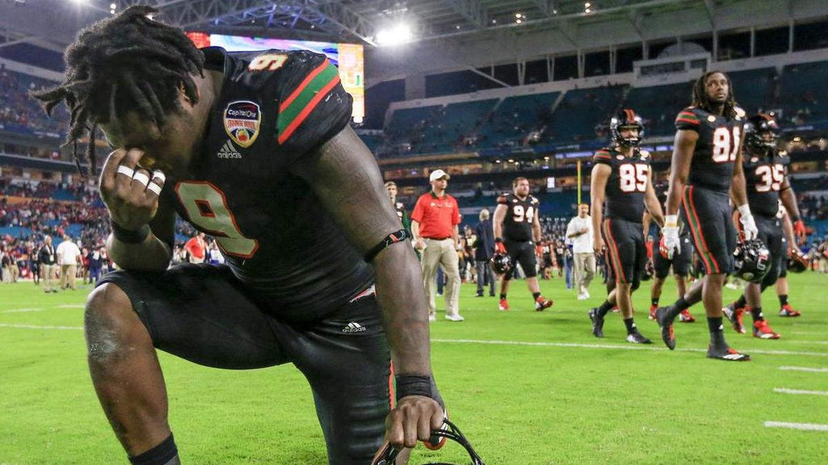 Miami Hurricanes defensive lineman Chad Thomas (9) takes a knee in the end zone after the University of Miami Hurricanes are defeated by the Wisconsin Badgers in the Capital One Orange Bowl game at Hard Rock Stadium on Saturday, December 30, 2017