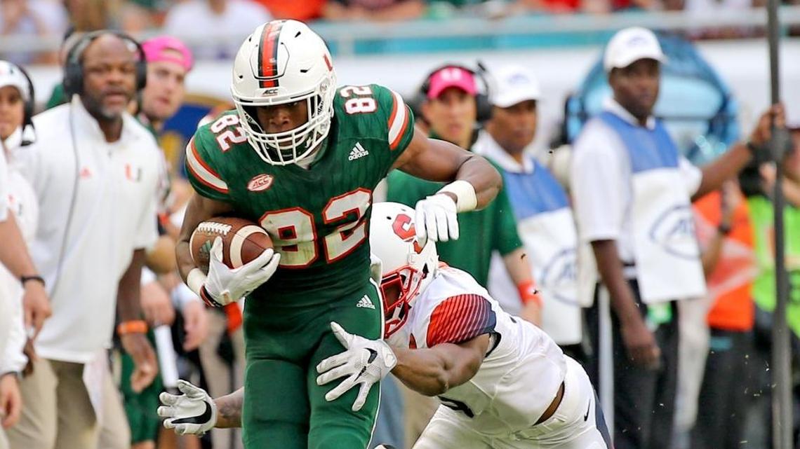 Miami Hurricanes Ahmmon Richards (82) catches a second quarter pass as Syracuse University Christopher Fredrick (3) tackles him at Hard Rock Stadium in Miami Gardens, Florida, Oct. 21, 2017.