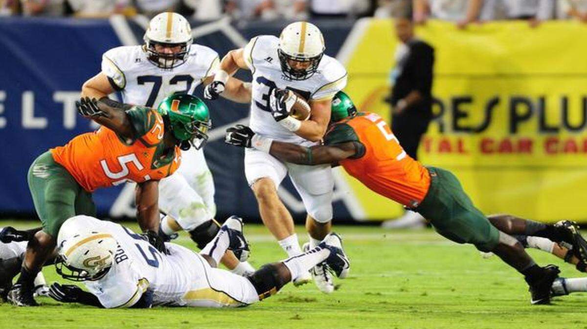 
Zach Laskey #37 of the Georgia Tech Yellow Jackets carries the ball against Jermaine Grace #5 of the Miami Hurricanes at Bobby Dodd Stadium on October 4, 2014 in Atlanta, Georgia. 
