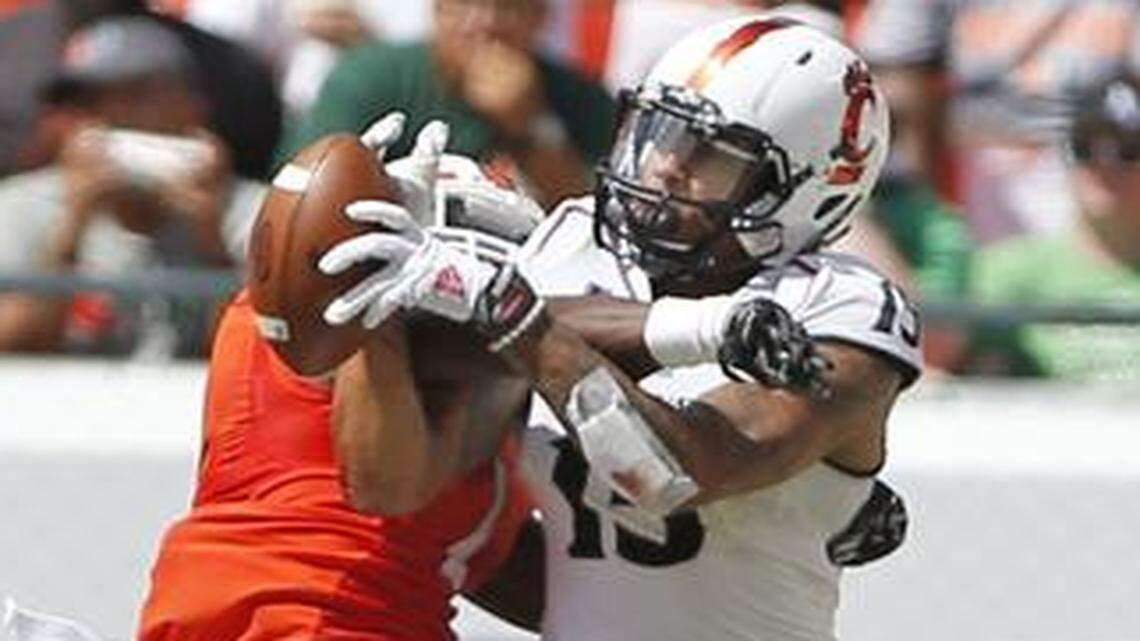 
Miami Hurricanes defensive back Artie Burns (1) deflects a pass intended for Cincinnati Bearcats wide receiver Chris Moore (15) in the second quarter as the University of Miami hosts Cincinnati at Sun Life Stadium on Saturday, October 11, 2014.
