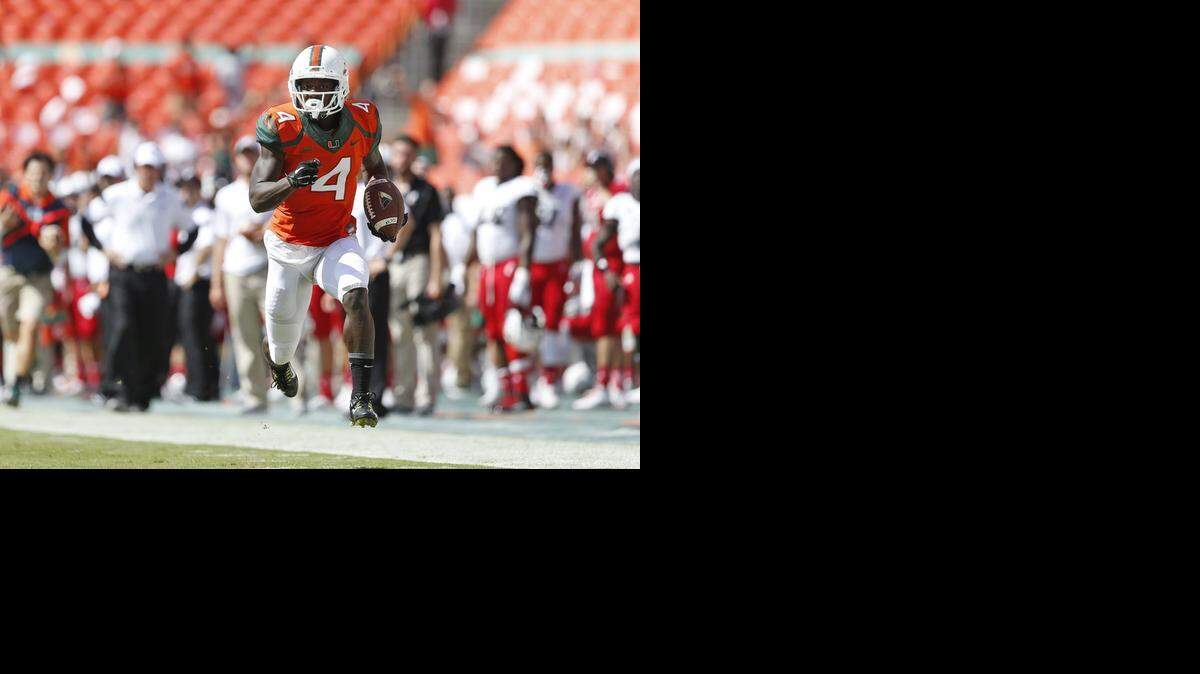 
Phillip Dorsett of the Miami Hurricanes runs for a third-quarter touchdown against the Cincinnati Bearcats on October 11, 2014 at Sun Life Stadium in Miami Gardens, Florida. 
