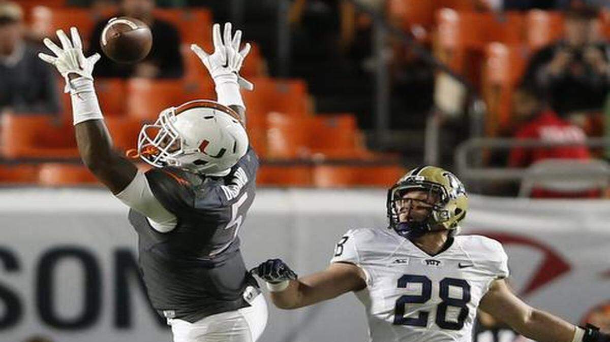 
Miami Hurricanes tight end Standish Dobard (5) can't get his hand on the ball on an incomplete pass in the third quarter of UM's game against Pittsburgh at Sun Life Stadium on Saturday, Nov. 29, 2014.
