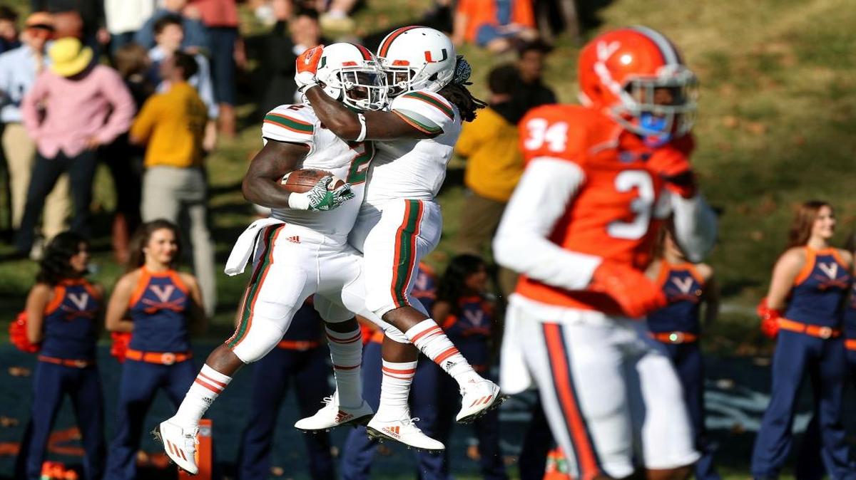 Miami wide receiver Malcolm Lewis, right, celebrates after running back Joseph Yearby’s first-half touchdown.