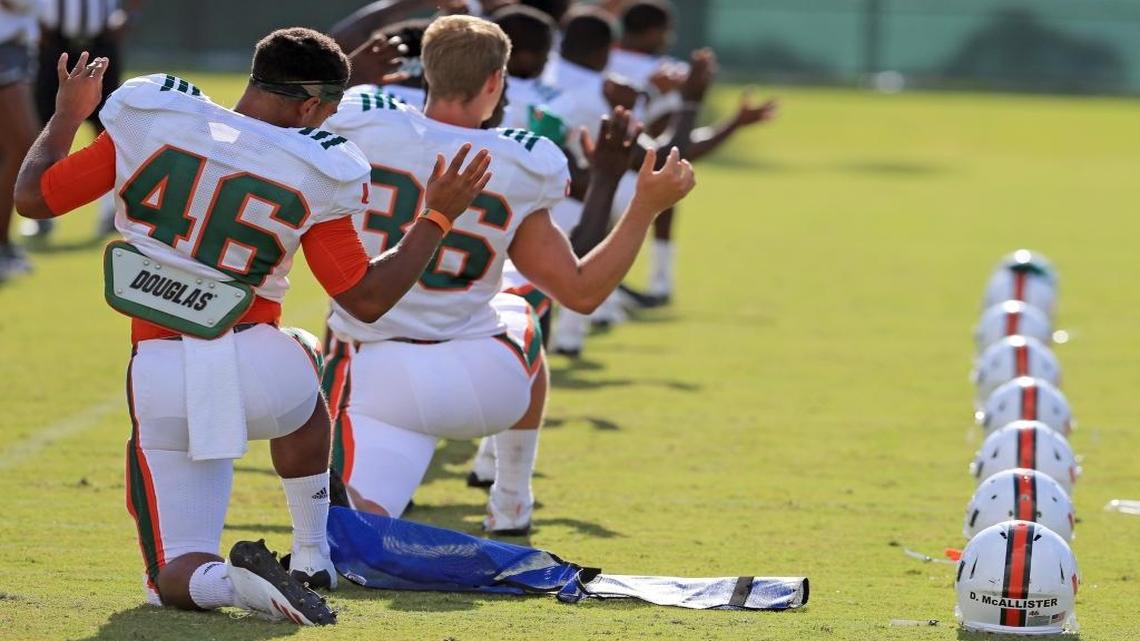 Daniel Ferguson-McAllister (46) stretches during practice at the University of Miami football camp at Greentree Field on Wednesday, Aug. 9, 2017.