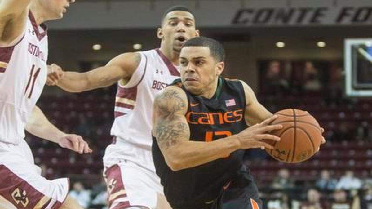 
Miami's Angel Rodriguez attempts to dodge Boston College players during a game at Boston College on Monday, Feb. 16, 2015.
