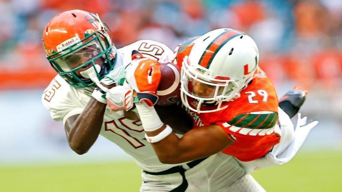 Miami Hurricanes defensive back Corn Elder (29) intercepts the ball intended for Florida A&M Rattlers wide receiver Montavius Williams (15) in the first quarter at Hard Rock Stadium on Saturday, Sept. 3, 2016.