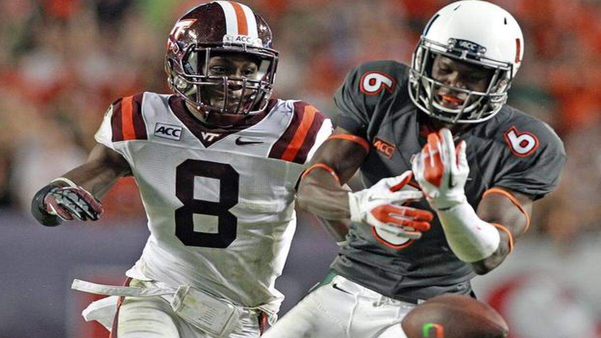 
UM receiver Herb Waters drops a pass near the end zone in the third quarter as Virginia Tech’s Detrick Bonner watches at Sun Life Stadium in Miami Gardens, Florida, Nov. 10, 2013.
