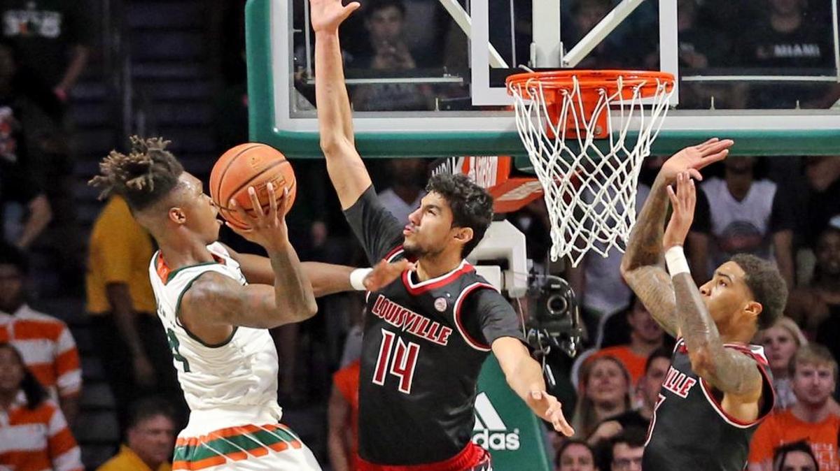 Miami Hurricanes Lonnie Walker scores and ties the score at the end of regulation as Louisville Cardinals Anas Mahmoud fails to defend at the WATSCO Center in Coral Gables, January 24, 2018.