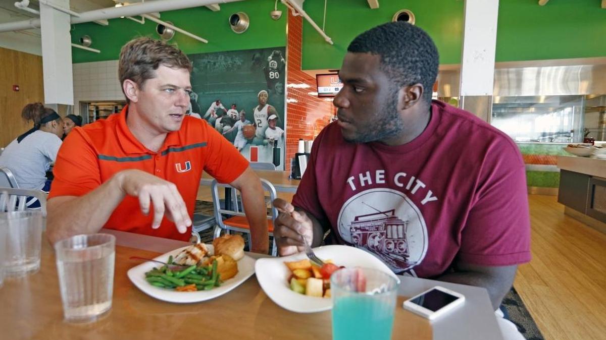 
Nutrition educator Tony Musto talks with University of Miami defensive lineman Calvin Heurtelou on the UM campus, Sept. 23, 2015.
