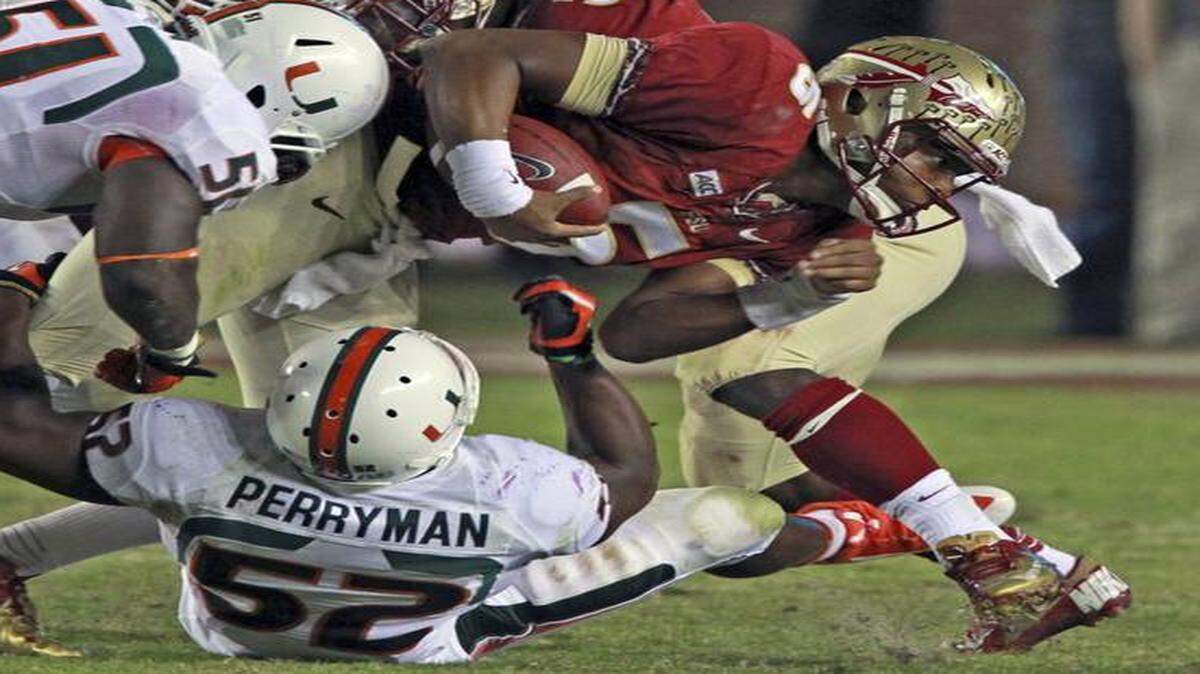 
UM defenders take down FSU quarterback Jameis Winston at Doak Campbell Stadium in Tallahassee, Florida, Nov. 2, 2013.
