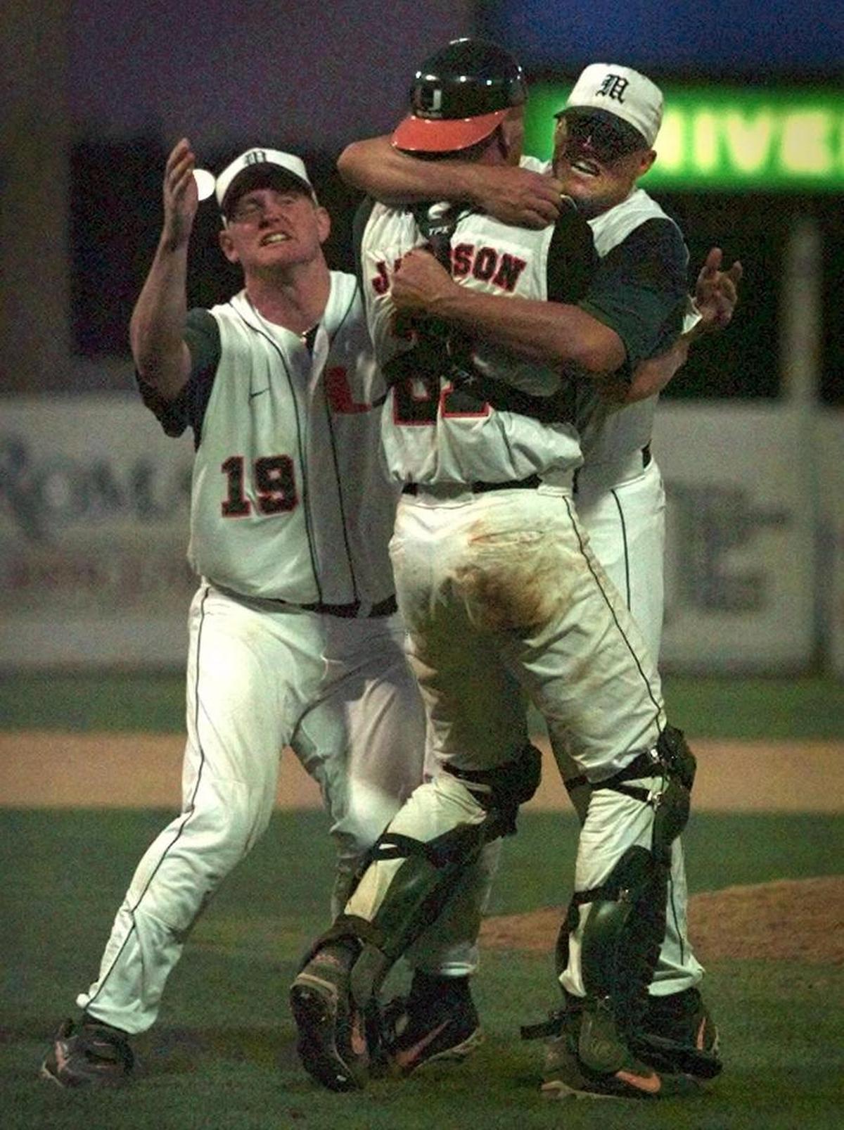 University of Miami Hurricanes defeat University of North Carolina 7-4 to win the Atlantic I NCAA Regional at Mark Light Stadium and advance to the College World Series in 1998. Pitcher Robbie Morrison, right, hugs catcher Russ Jacobson as Aubrey Huff (19) joins the celebration.