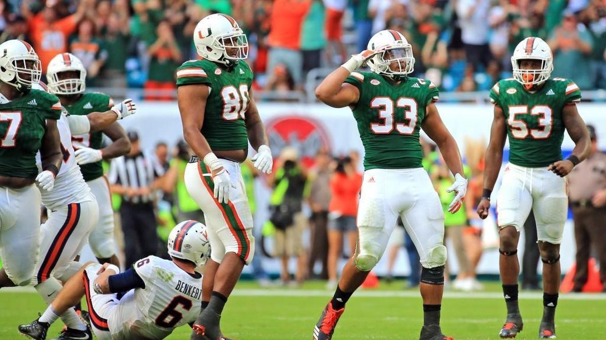 Miami Hurricanes defensive end Trent Harris (33) reacts after sacking Virginia Cavaliers quarterback Kurt Benkert in the fourth quarter at Hard Rock Stadium on Saturday, November 18, 2017.