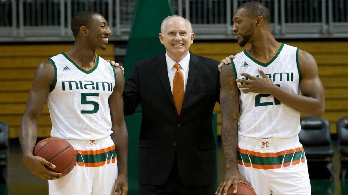 UM guard Davon Reed (5) and forward Kamari Murphy (21) laugh with head coach Jim Larrañaga as they pose for photos Tuesday, Oct. 13, 2015, during Miami’s NCAA basketball Media Day in Coral Gables, Fla.