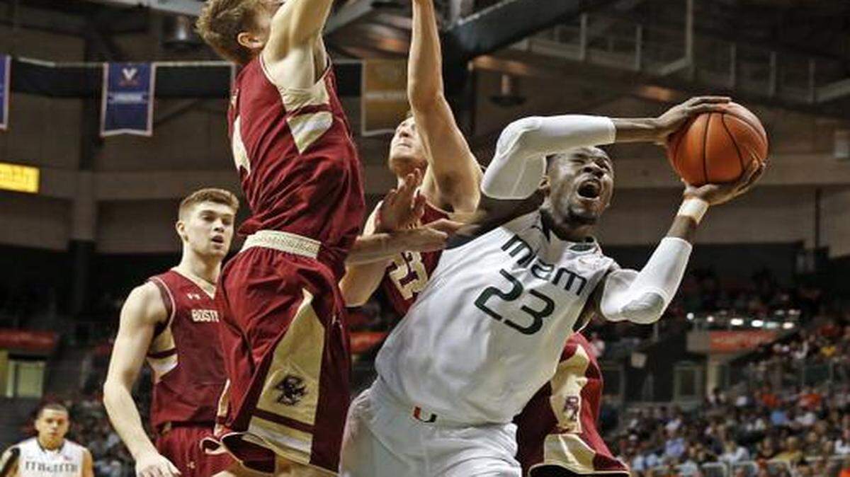 
Hurricanes center Tonye Jekiri (23) battles through Boston College defenders in the first half. Jekiri tied his season high with 13 points.
