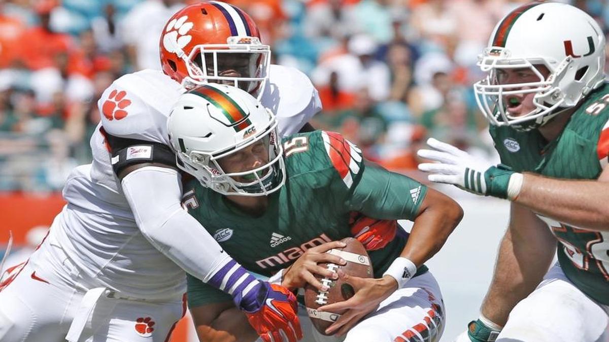 Miami's Brad Kaaya is sacked by Clemson's Shaq Lawson in the first quarter as the University of Miami hosts Clemson at Sun Life Stadium on Saturday, October 24, 2015.