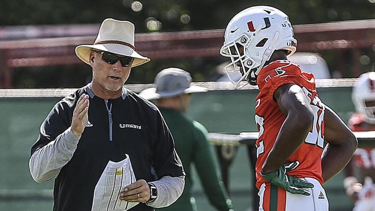 Miami coach Mark Richt gives instruction to wide receiver Ahmmon Richards as the Hurricanes practice at Greentree Practice field on Aug. 23. Richards was sidelined on a conditioning bike during practice on Tuesday.