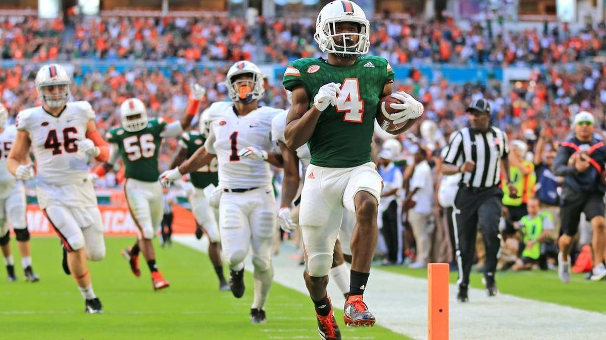 Miami Hurricanes safety Jaquan Johnson (4) returns an interception for a third quarter touchdown during the UM-Virginia game last November. According to evaluators and analysts, Johnson projects as a first- or second-day draft pick next April.