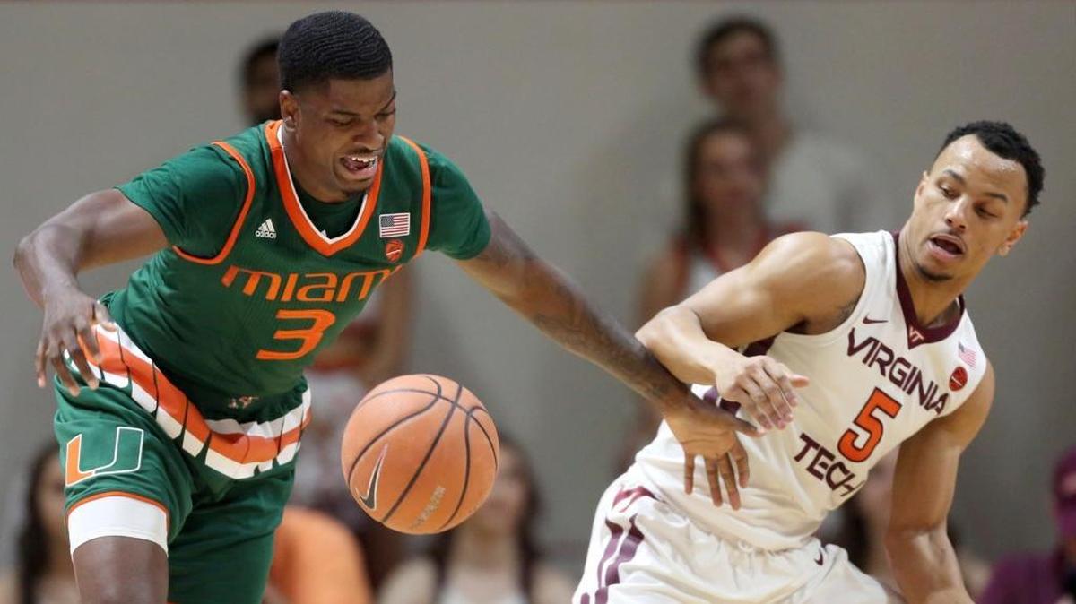 Miami's Anthony Lawrence II (3) battles for a loose ball with Virginia Tech's Justin Robinson (5) during the second half of an NCAA college basketball game in Blacksburg, Va., Saturday Feb. 3 2018.