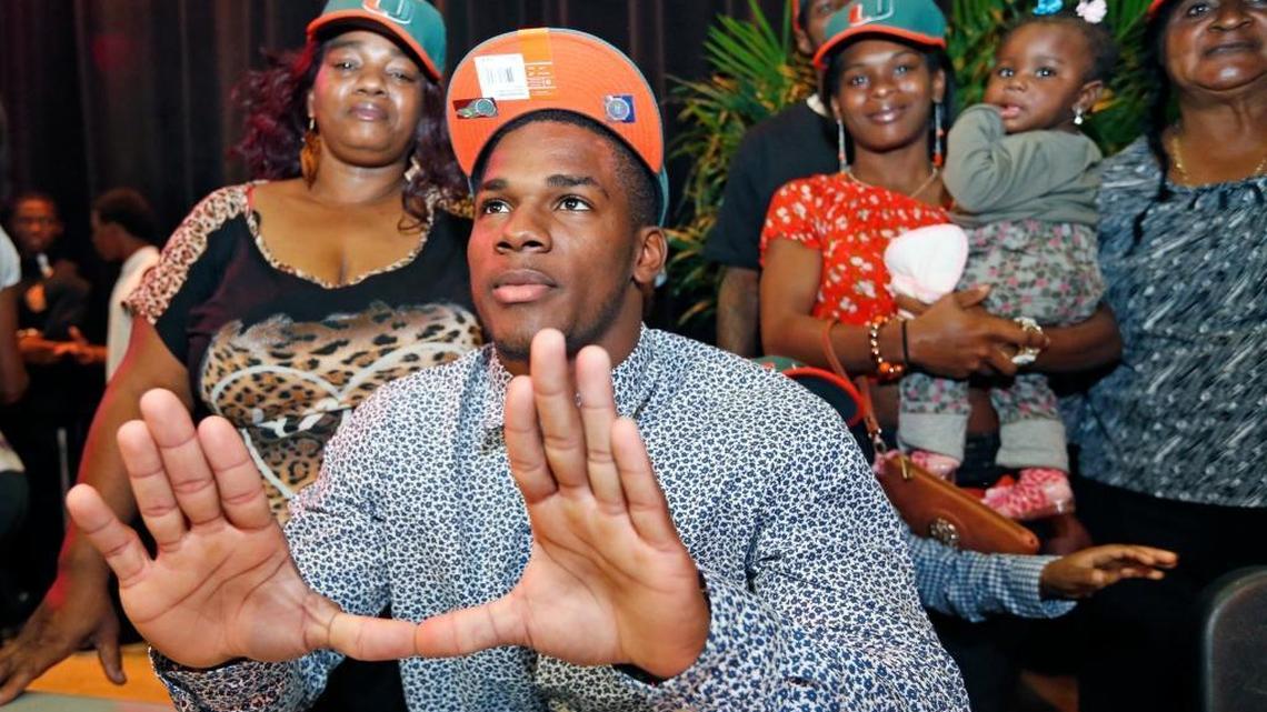 Mark Walton flashes the U after signing with the University of Miami during National Signing Day at Booker T. Washington with on Wednesday, February 4, 2015.