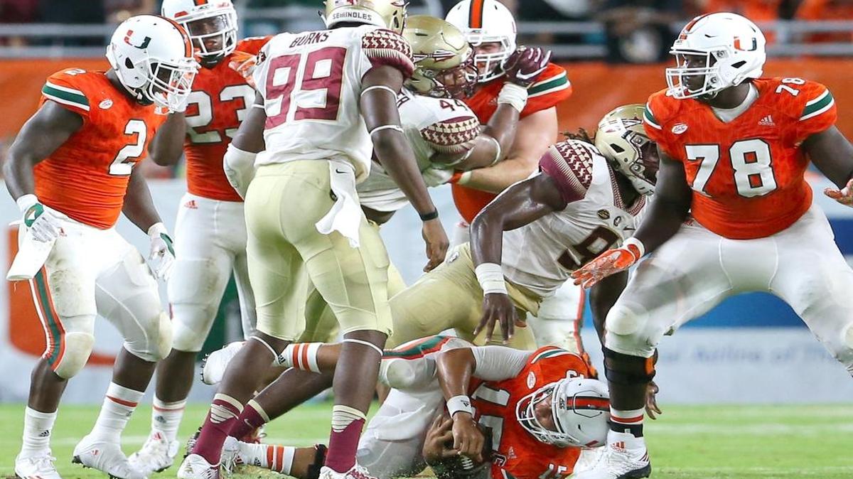 University of Miami Hurricanes quarterback Brad Kaaya,15, being sacked by Florida State Seminoles defensive end Josh Sweat,9, in the fourth quarter of an NCAA college football game at Hard Rock Stadium on Sat., Oct. 8, 2016, in Miami Gardens.