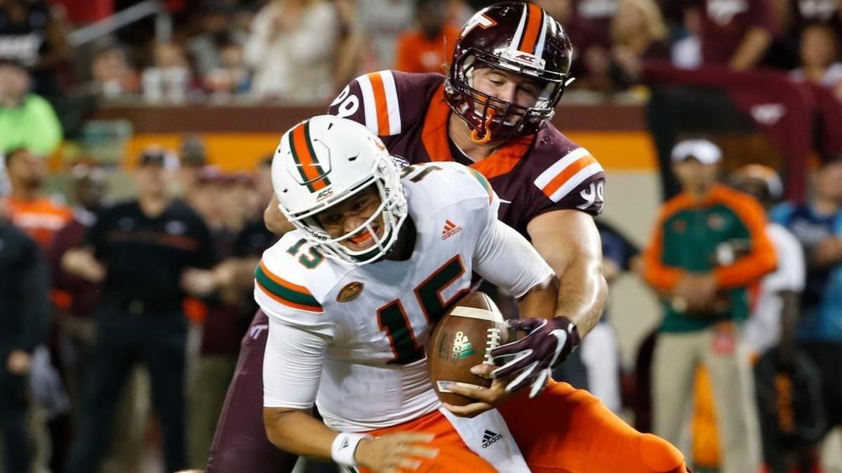 Miami quarterback Brad Kaaya (15) is sacked by Virginia Tech defensive lineman Vinny Mihota (99) during the second half of an NCAA college football game at Lane stadium in Blacksburg, Va., Thurs., Oct. 20, 2016.