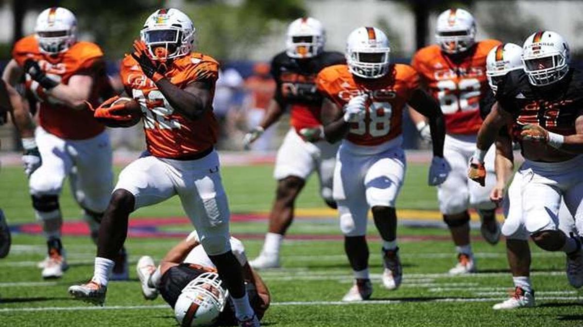 Miami Hurricanes’ running back, Trayone Gray, 32, breaks away from defenders during a scrimmage at Oxbridge Academy in West Palm Beach, Fla., on Saturday, April 9, 2016. The game is the public’s first opportunity to look at Mark Richt’s team.