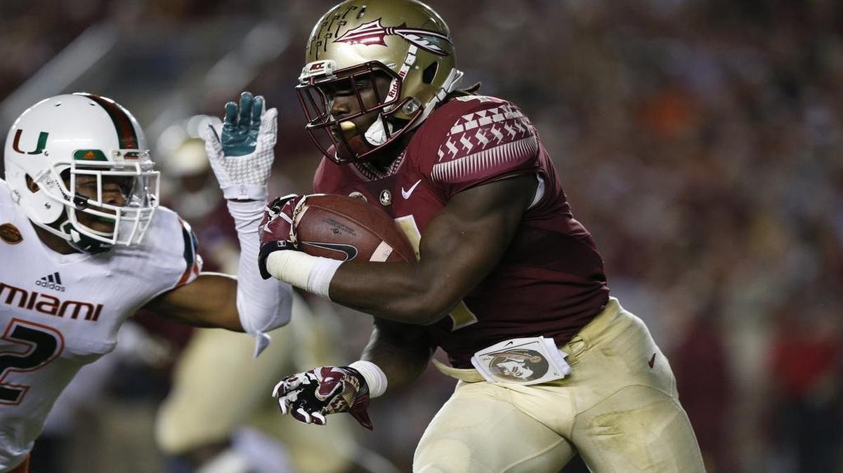 
Florida State running back Dalvin Cook takes off with the ball during Saturday night’s game, during which he gained a season-high 137 yards in the first half alone. It was Cook’s eighth career game of more than 100 yards.
