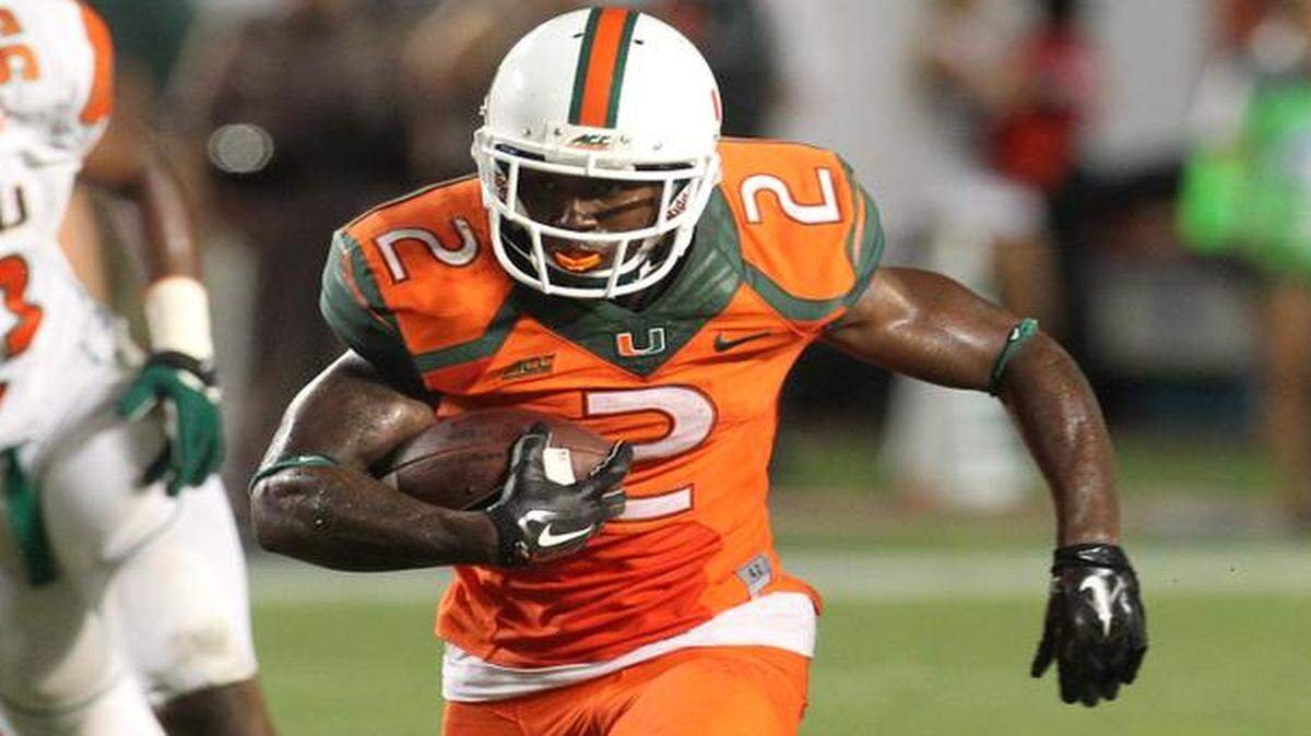 
Joe Yearby runs for a first down against Florida A&M at Sun Life Stadium in Miami Gardens, Florida, on Sept. 6, 2014.

