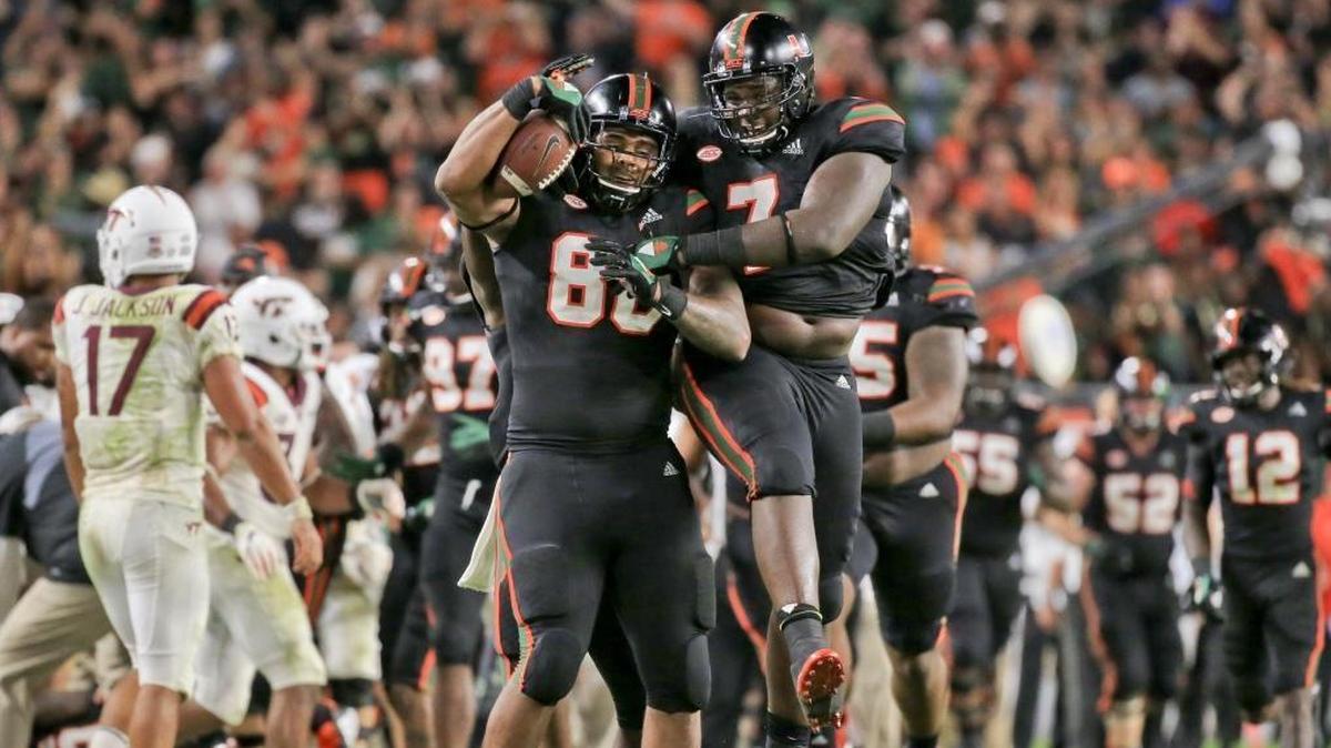 Miami Hurricanes defensive tackle RJ McIntosh (80) celebrates with teammate Kendrick Norton after recovering a fumble against Virginia Tech at Hard Rock Stadium on Saturday, November 4, 2017.