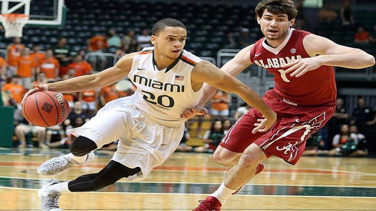 
Miami Hurricanes' Manu Lecomte drives past Alabama's Riley Norris in the first half of the University of Miami Hurricanes vs University of Alabama, game at Bank United Center at UM on Saturday, March 21, 2015.

