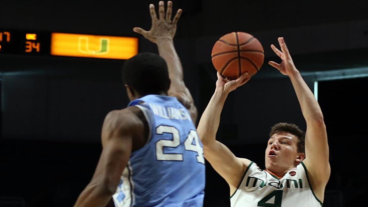 UM Hurricanes' guard Dejan "DJ" Vasilijevic, shoots to the basket against North Carolina's Kenny Williams, in the second half of the University of Miami Hurricanes vs University of North Carolina, game at Watsco Center at UM on Sat., Jan. 28, 2017.