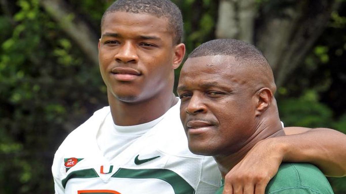Former UM player Deon Bush poses with his father, Gary Bush, in this July 26, 2013, file photo. Bush – a well-loved Miami-Dade teacher, community stalwart and father of former Miami Hurricane and current Chicago Bear Deon Bush – took his last breath in the hospice unit of University of Miami Hospital.