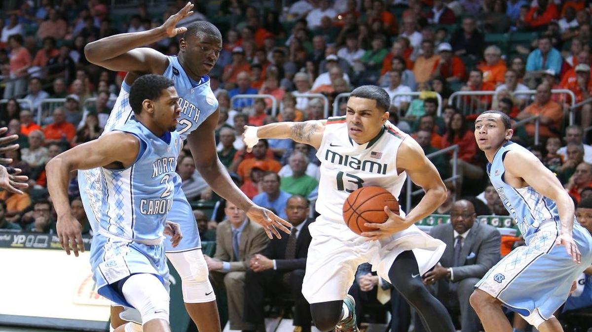 UM point guard Angel Rodriguez tries to drive through three North Carolina defenders during a game at BankUnited Center in Coral Gables on Saturday, February 28, 2015.