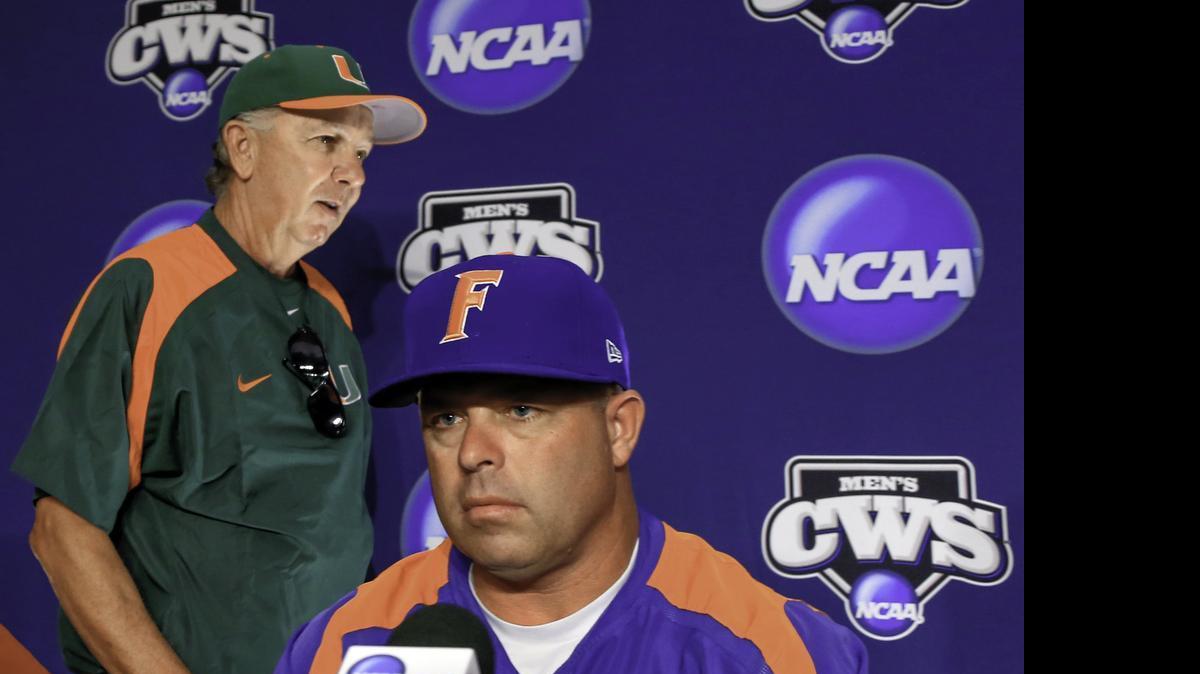 
UM coach Jim Morris, left, walks past Florida coach Kevin O'Sullivan at the start of a coaches news conference, Friday, June 12, 2015, at TD Ameritrade Park in Omaha, Neb.

