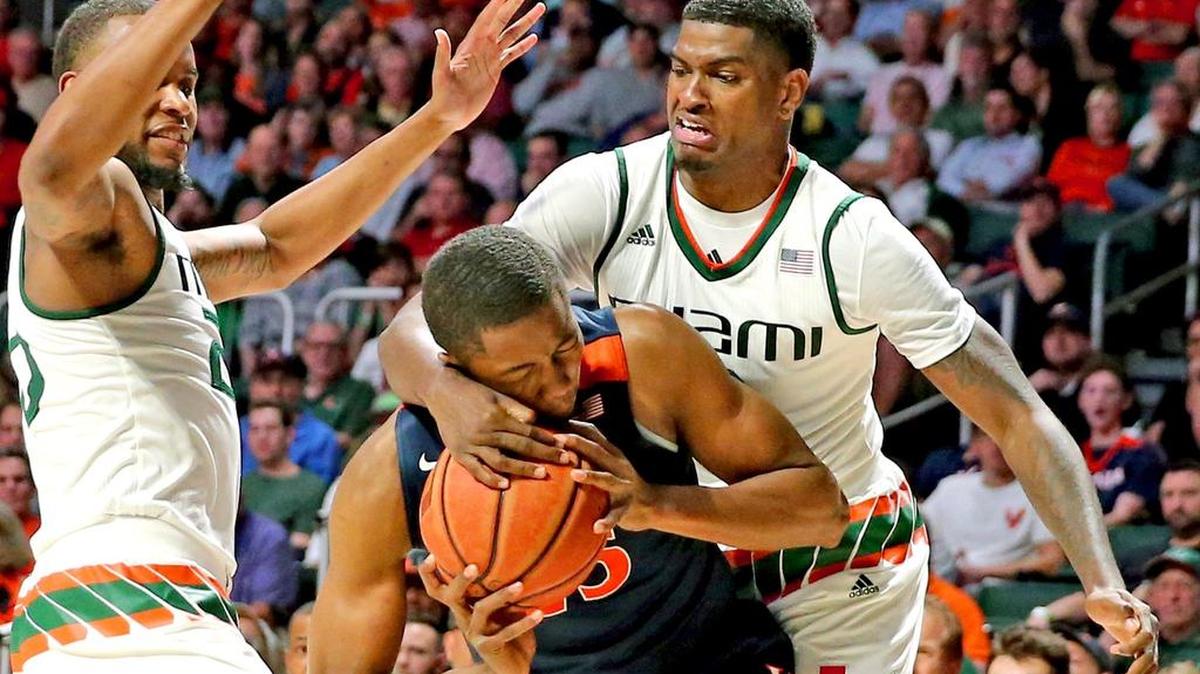 Miami Hurricanes Anthony Lawrence (3) tries to strip the ball from Virginia Cavaliers Mamadi Diakite (25) in the second period at the WATSCO Center in Coral Gables on Feb. 13.